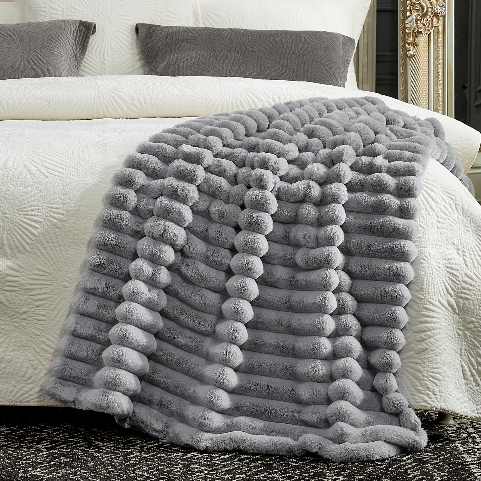 Cozy Bliss in hand scale comparison demonstrating generous 50x60 inch coverage
