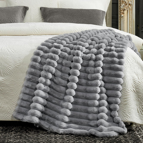 Cozy Bliss in hand scale comparison demonstrating generous 50x60 inch coverage
