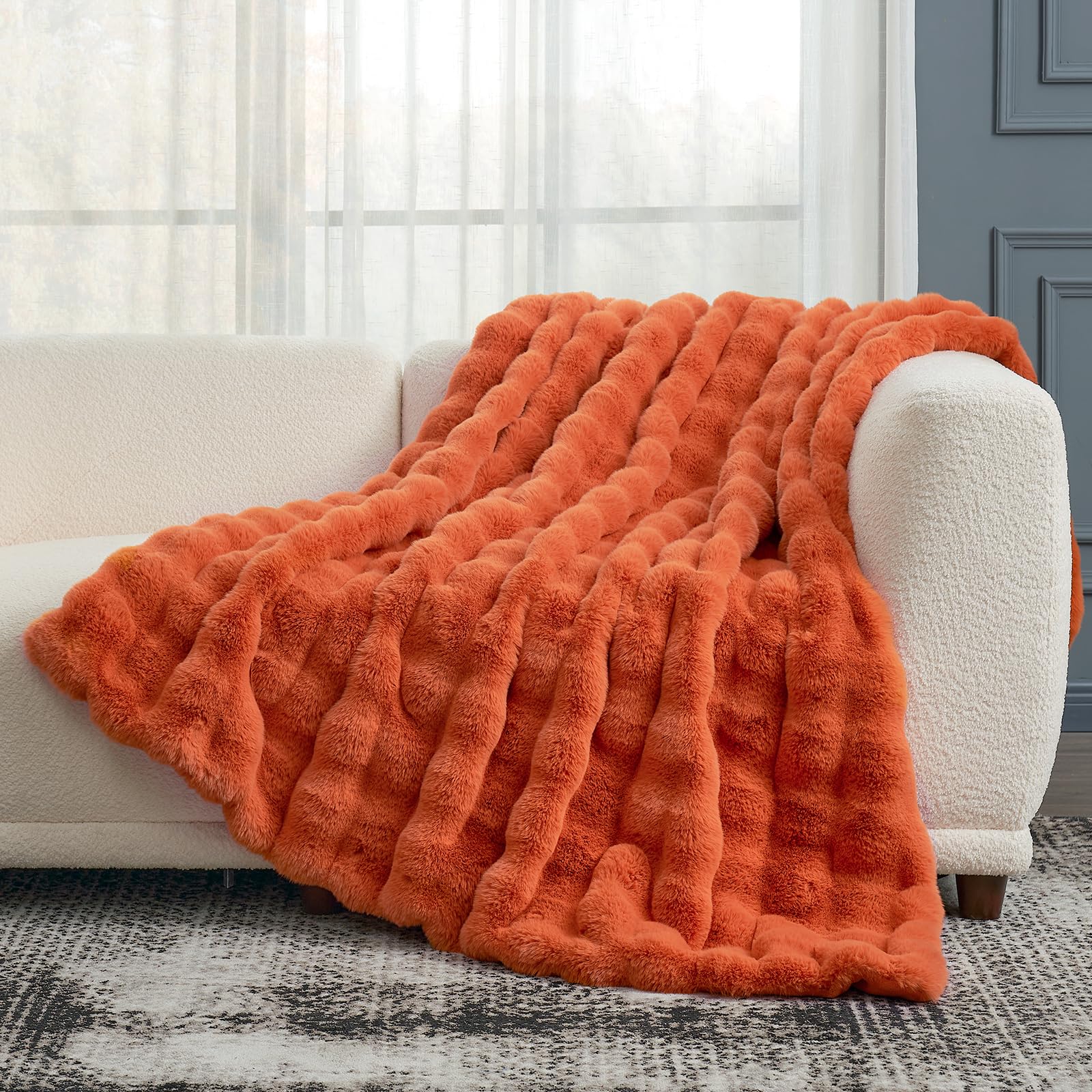 Cozy Bliss size comparison on chair illustrates 50x60 inch scale