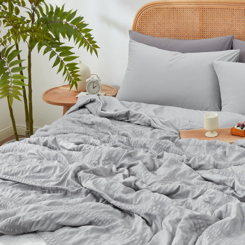 Cozy Bliss measuring tape beside comforter showing king-size dimensions