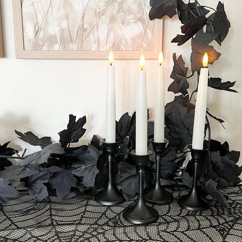 CQURE table centerpiece with garland and candles for dramatic Halloween or wedding decor