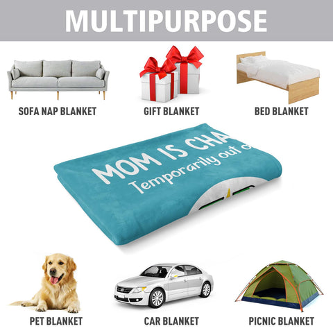 Craftique folded blanket beside a mug to show compact size and portability