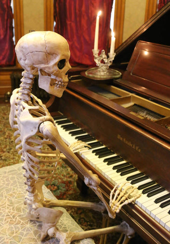 Crazy Bonez on a decorated porch creating spooky Halloween atmosphere