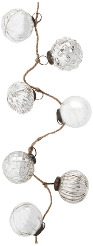 Creative Co-Op close-up of antique silver mercury glass texture, highlights reflective detail