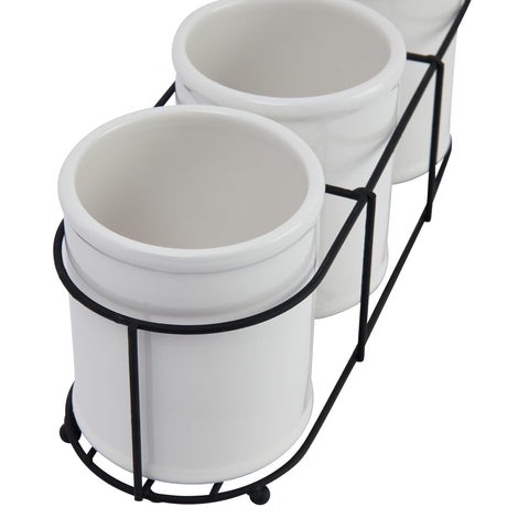 Creative Co-Op crocks on bathroom vanity holding brushes for space-saving benefit