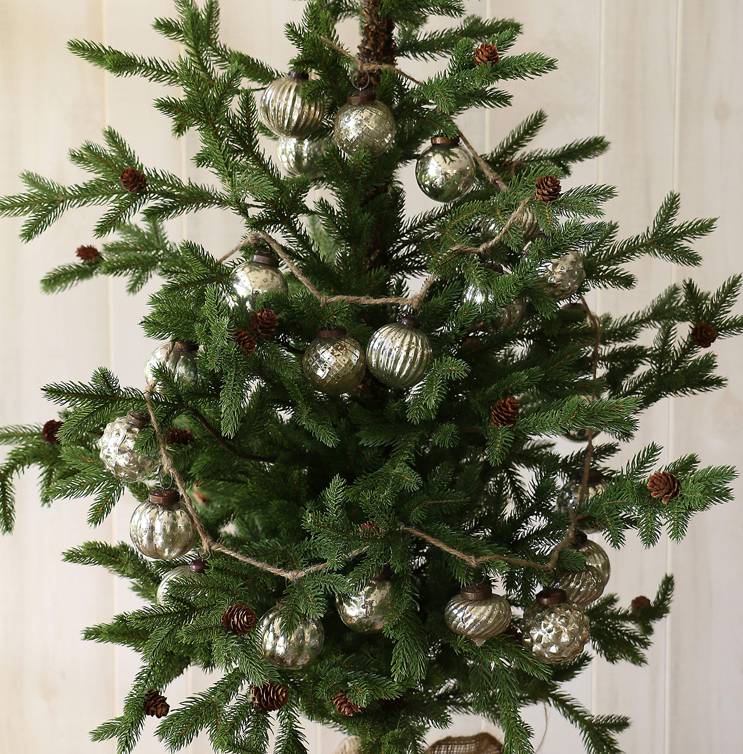 Creative Co-Op garland draped on mantel with greenery, adds vintage shimmer to display