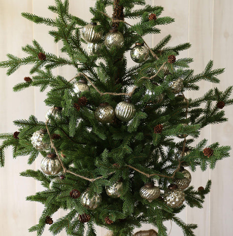 Creative Co-Op garland draped on mantel with greenery, adds vintage shimmer to display
