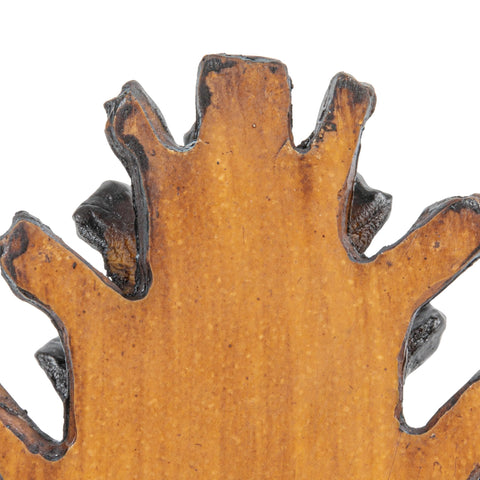 Creative Co-Op pinecone bookends supporting books on a living room shelf for organization