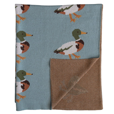 Creative Co-Op blanket beside stuffed toy illustrating 40 by 32 inch size for portability