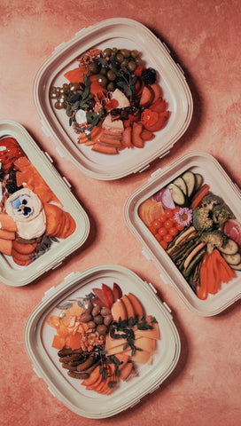 Crudités trays styled on a picnic blanket demonstrating outdoor entertaining ease