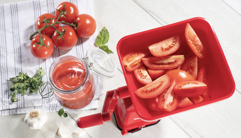 CucinaPro juice collection tray channeling liquid into a bowl for neat pouring