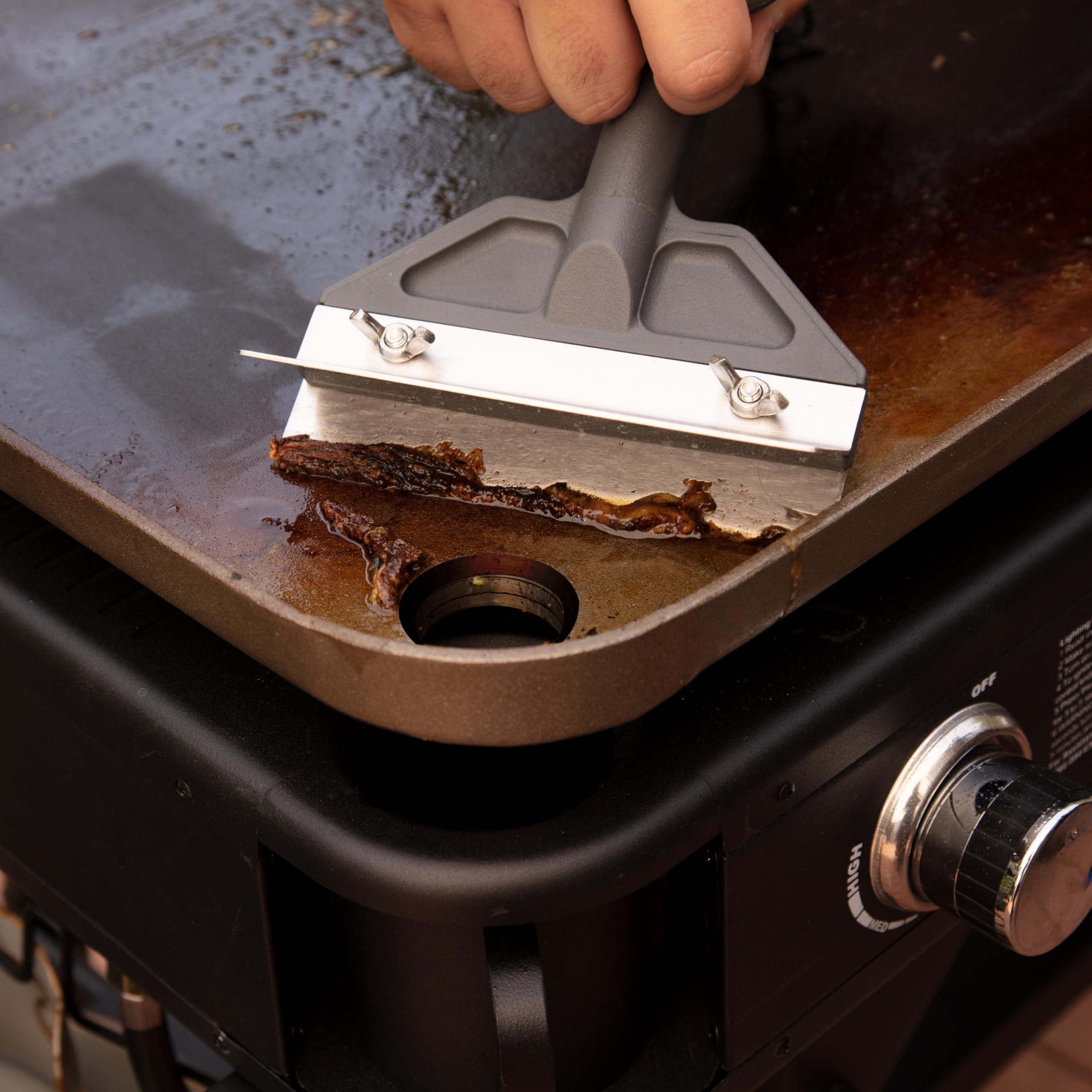 Cuisinart cleaned scraper stored on rack ready for next cookout maintaining hygiene