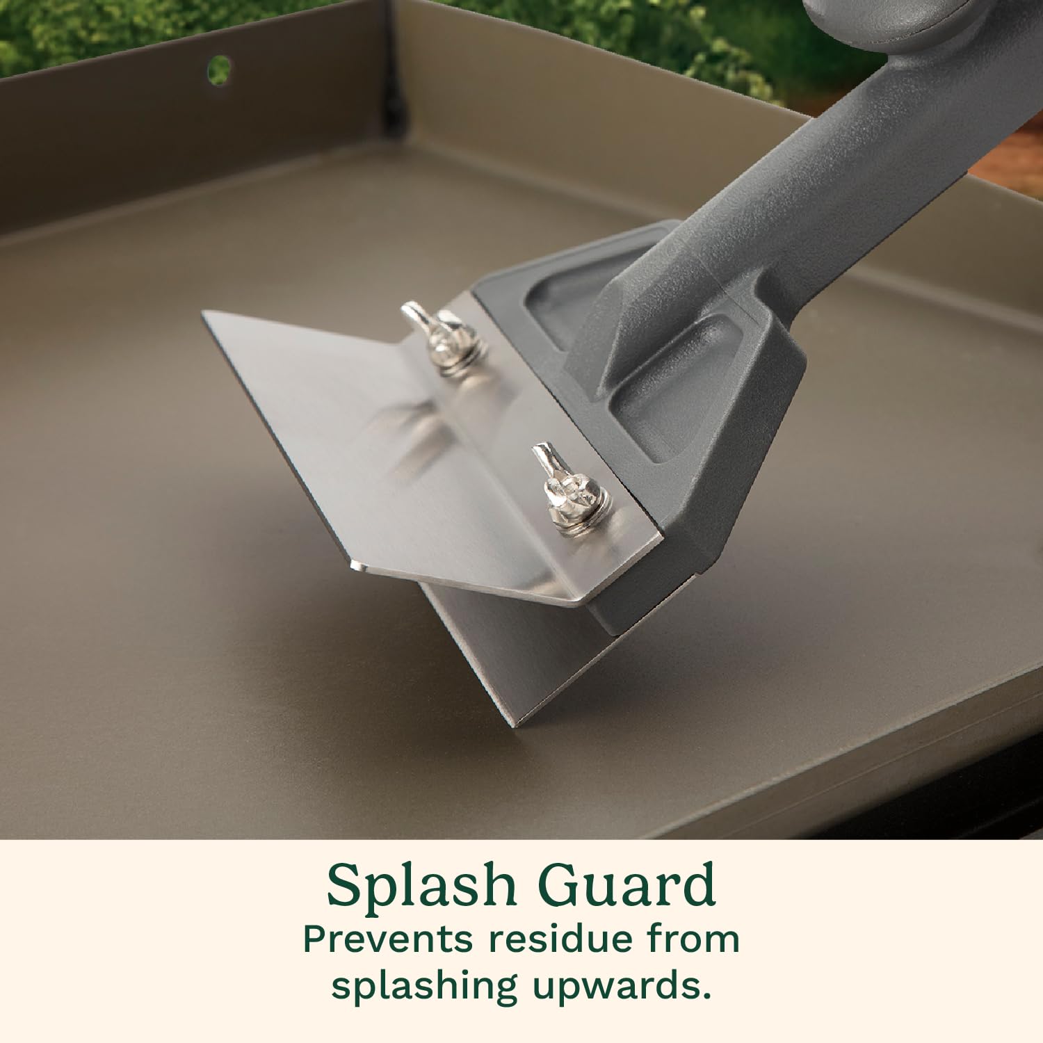 Cuisinart scraper in use on flat-top grill removing burnt-on food for faster cleaning