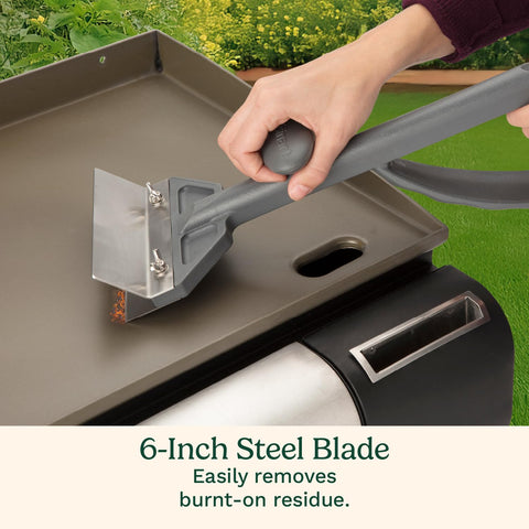 Cuisinart splash guard focus protecting hands from grease while scraping the griddle