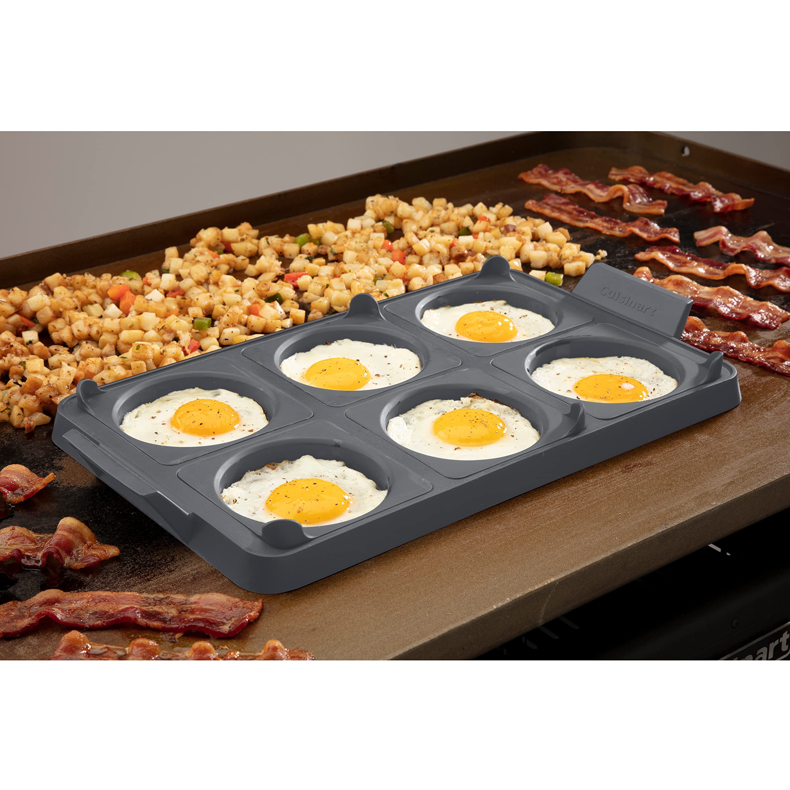 Cuisinart tray on griddle with eggs cooking for consistent shaped breakfast items