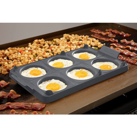 Cuisinart tray on griddle with eggs cooking for consistent shaped breakfast items