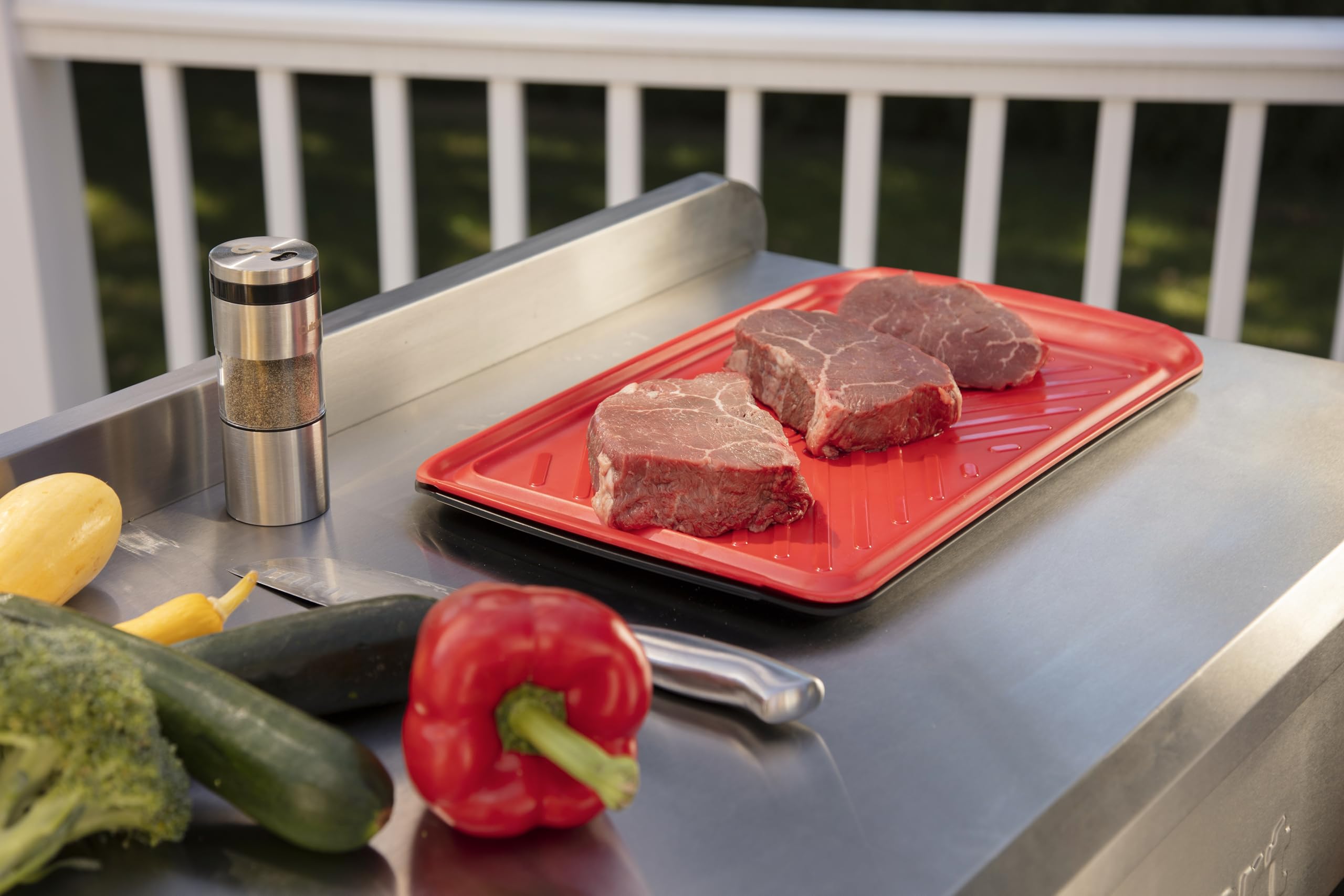 Cuisinart tray next to grill in backyard demonstrating convenient prep flow