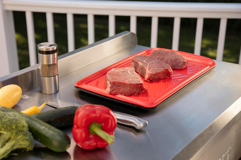 Cuisinart tray next to grill in backyard demonstrating convenient prep flow