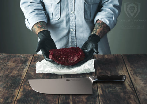 Dalstrong Ravager on cutting board near smoker in backyard for prep context