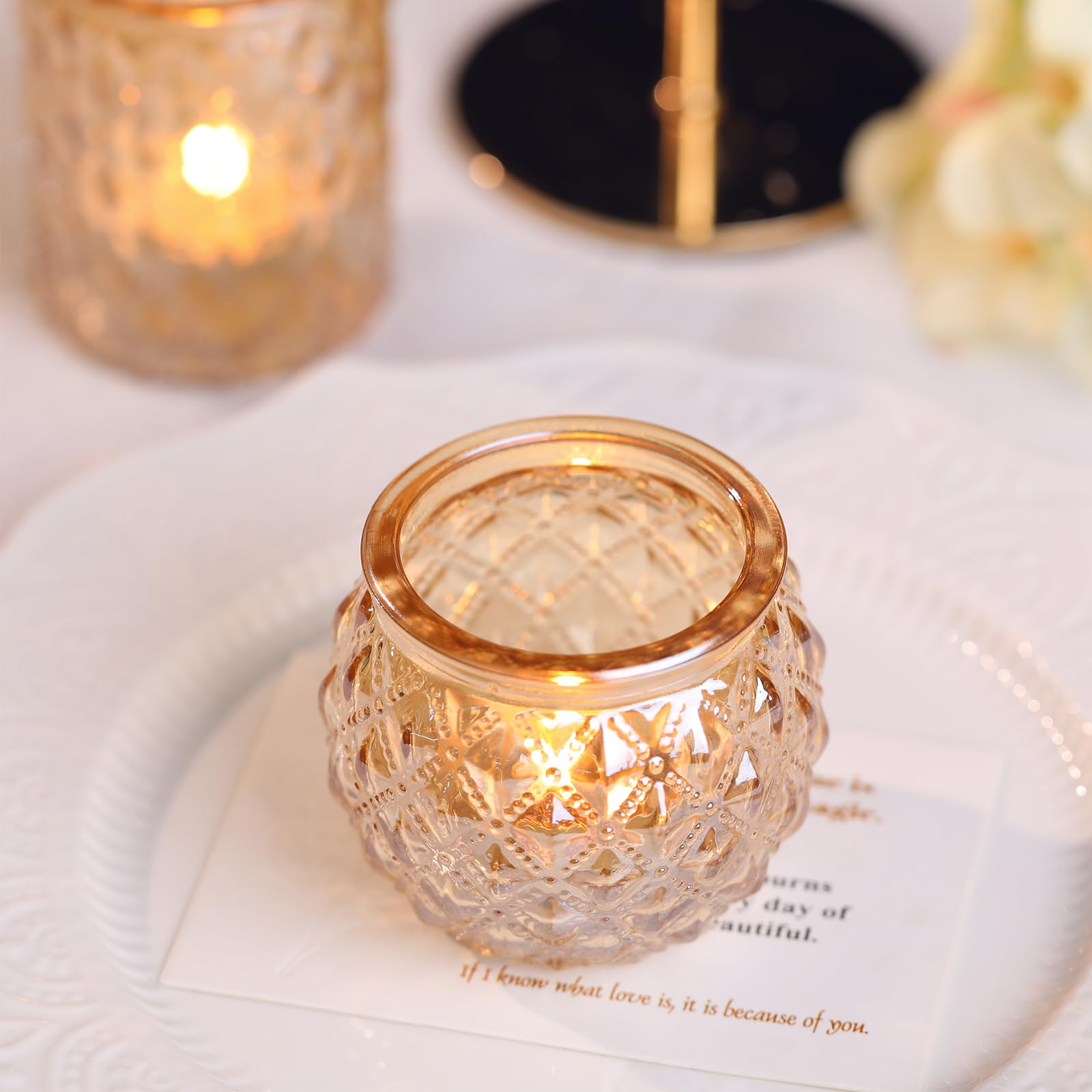 DARJEN gold votives lit on a table creating warm atmosphere for event benefit
