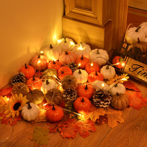 Hand holds a DearHouse mini pumpkin next to ruler to show scale and easy placement around home