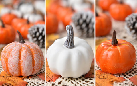 DearHouse arranged Thanksgiving centerpiece with pumpkins and leaves creating a warm harvest focal point