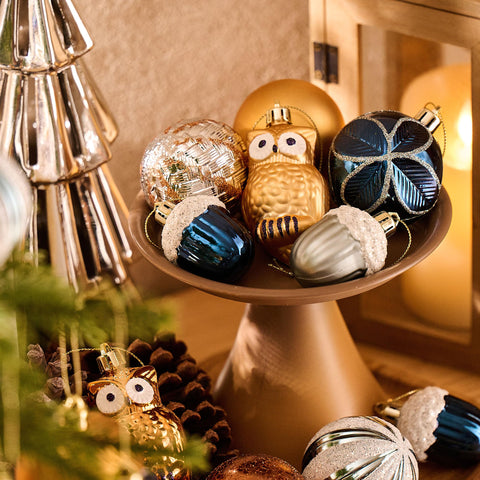 Decor by Hannah ornaments hung on a Christmas tree adding woodland blue and copper tone to holiday decor