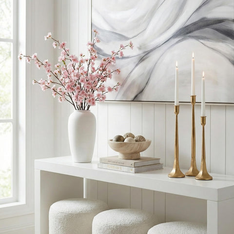 Denique candle holders shown with lit taper candles on a dining table creating warm ambient lighting