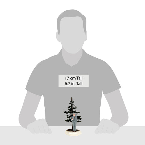 Department 56 figure next to candle showing scale for tabletop displays