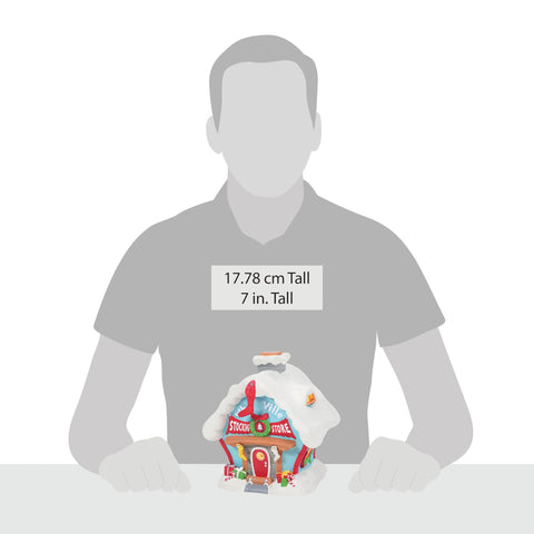 Department 56 beside figurine demonstrating scale and display compatibility