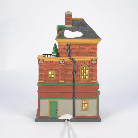 Department 56 Murphy's pub on mantel with trees and figures showcasing display impact