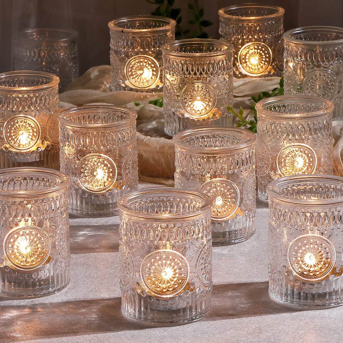 DEVI front view of 24 clear glass votive holders showing set and finish benefits