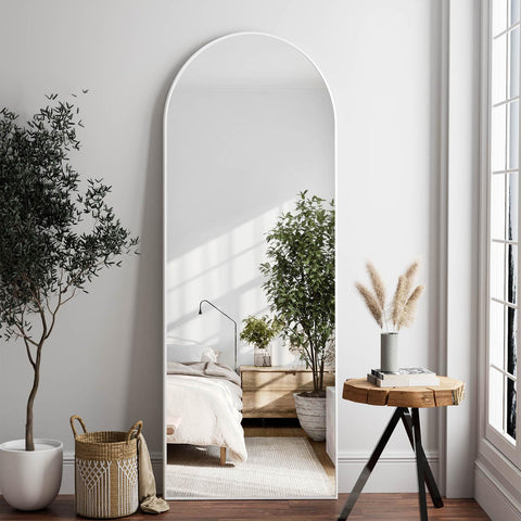 Dewfig front view of arched full-length mirror brightens room