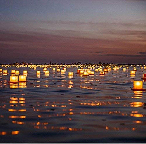 Diagtree lake-side wedding display of multiple floating lanterns creating romantic ambiance