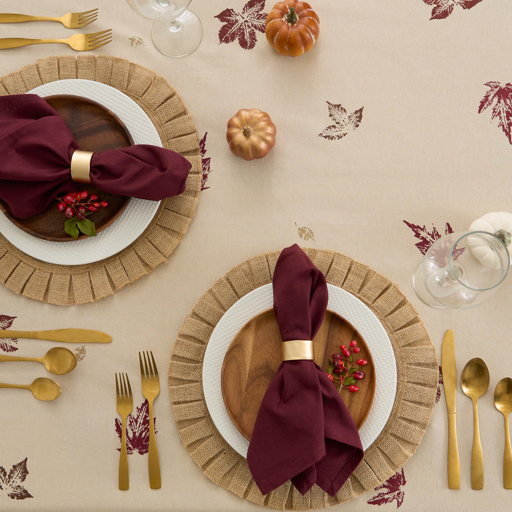 DII tablecloth styled with plates candles and pumpkins creating a cozy fall tablescape