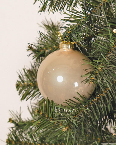 DN DECONATION ornaments hanging on a Christmas tree adding elegant champagne tone and depth
