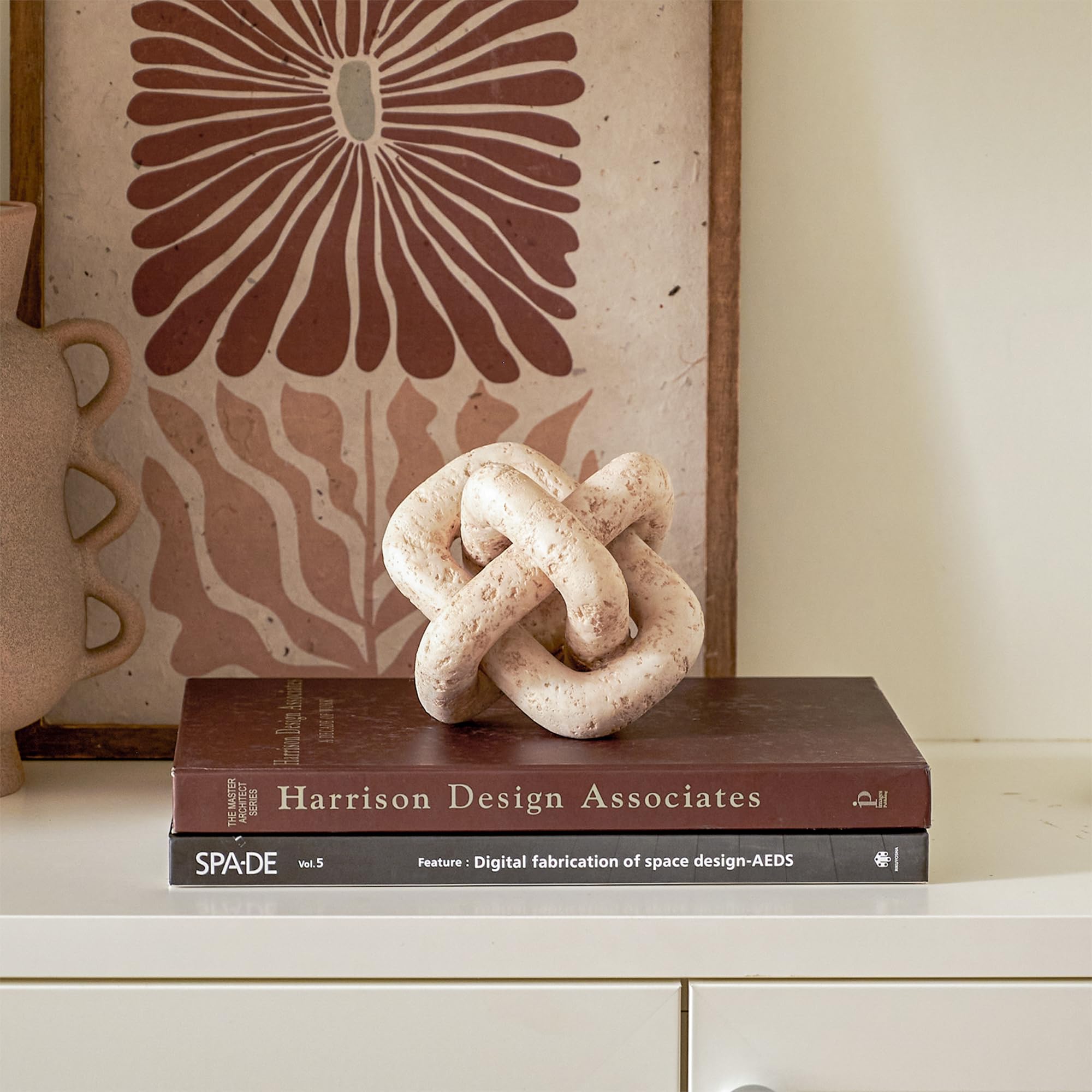 DN DECONATION knot next to a hand for size comparison showing easy placement benefit