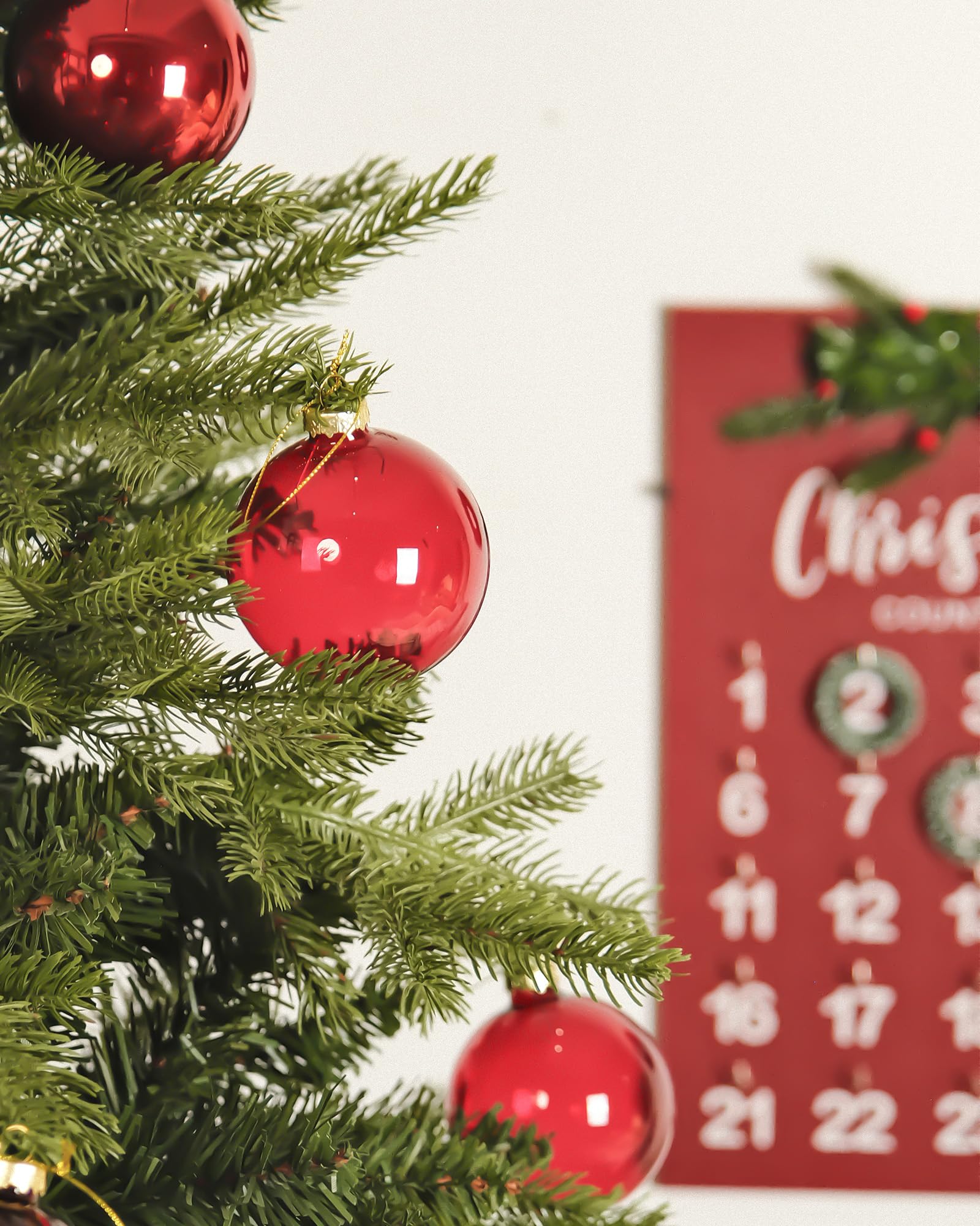 DN DECONATION ornaments hung on a decorated tree adding classic holiday depth