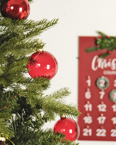 DN DECONATION ornaments hung on a decorated tree adding classic holiday depth