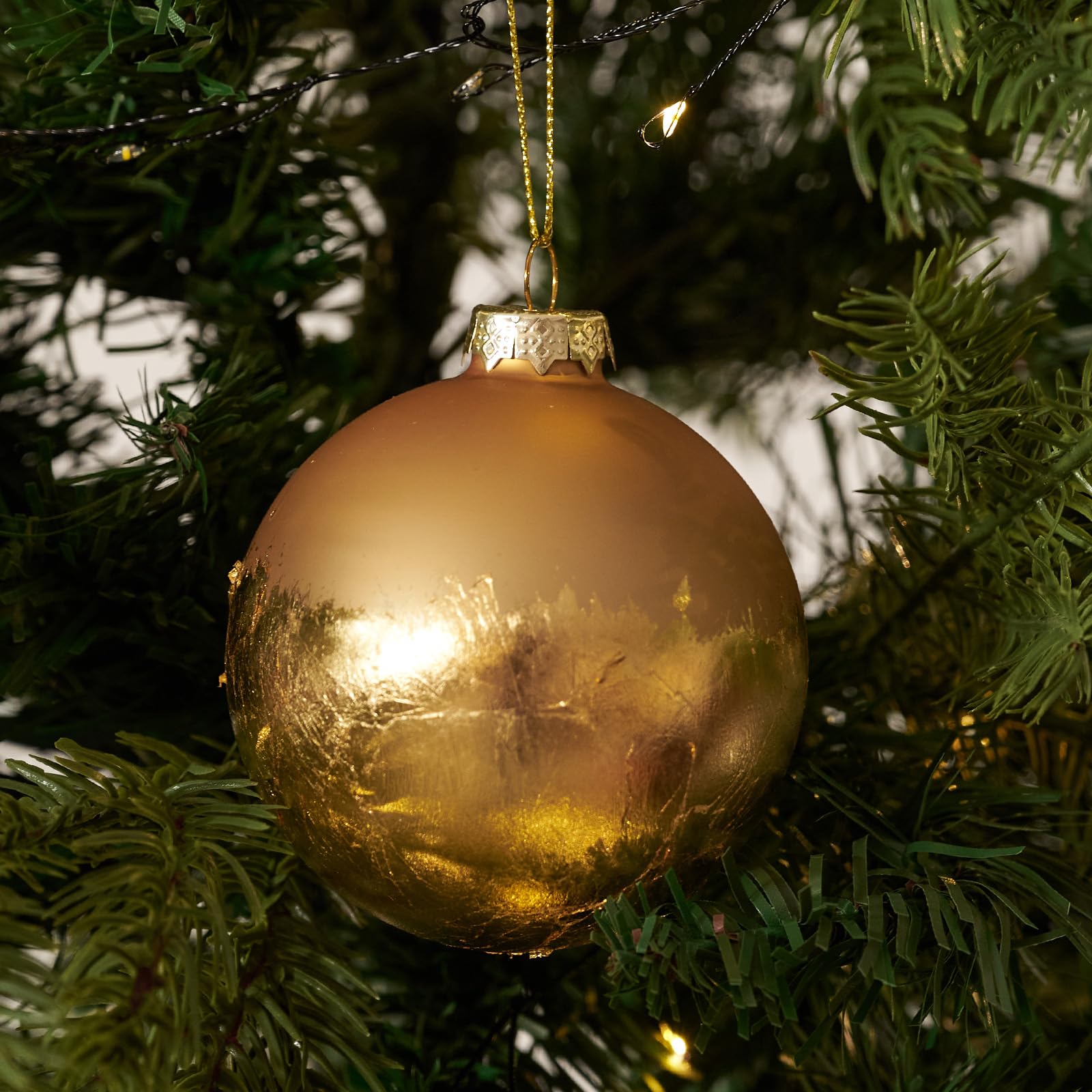 DN DECONATION ornament next to a ruler showing 3.14-inch size for scale