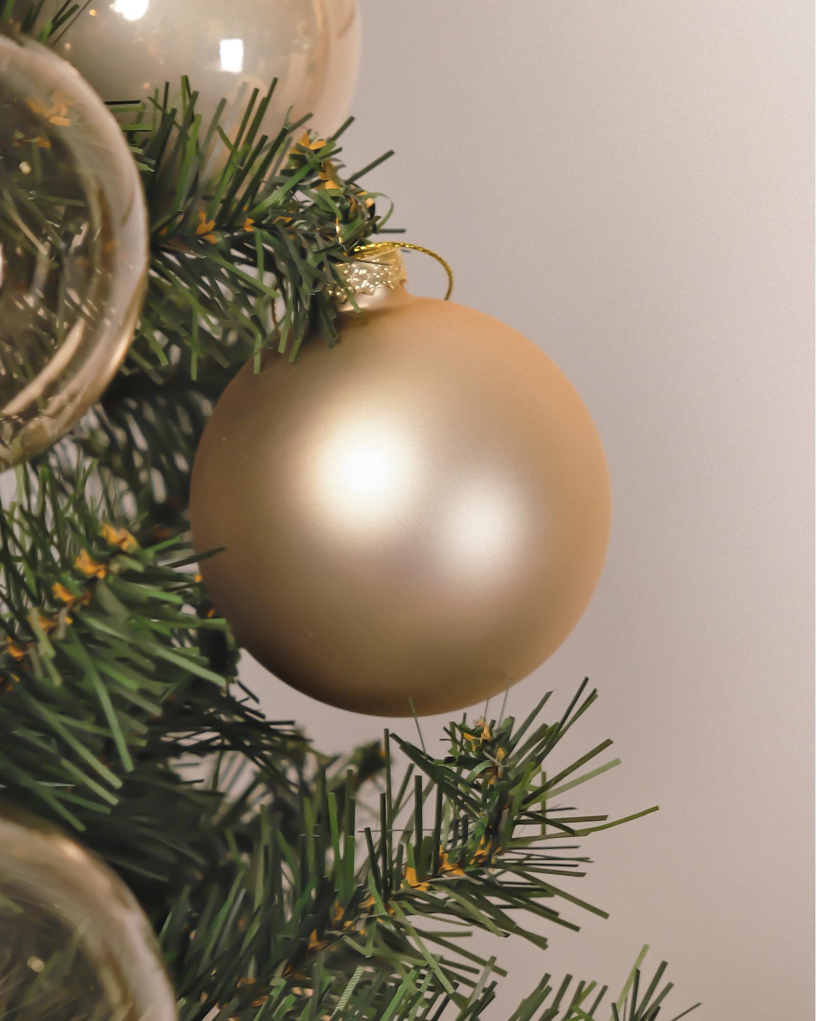 DN DECONATION ornament in hand for scale illustrating the 3.15-inch size and lightweight feel