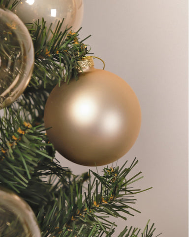 DN DECONATION ornament in hand for scale illustrating the 3.15-inch size and lightweight feel