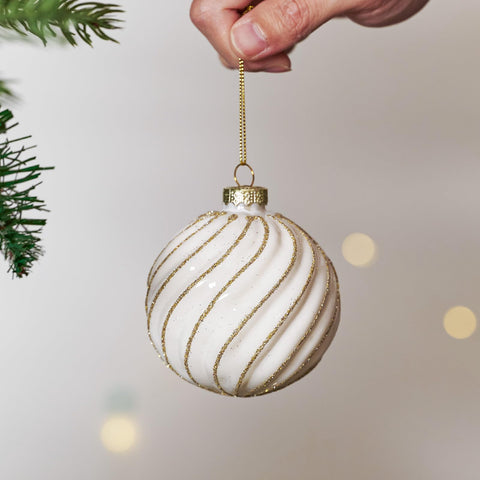 DN DECONATION ornament held in hand showing 3.14-inch scale for planning placement