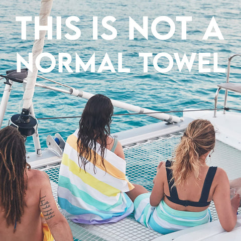 Dock & Bay towel next to a water bottle illustrating large size and scale