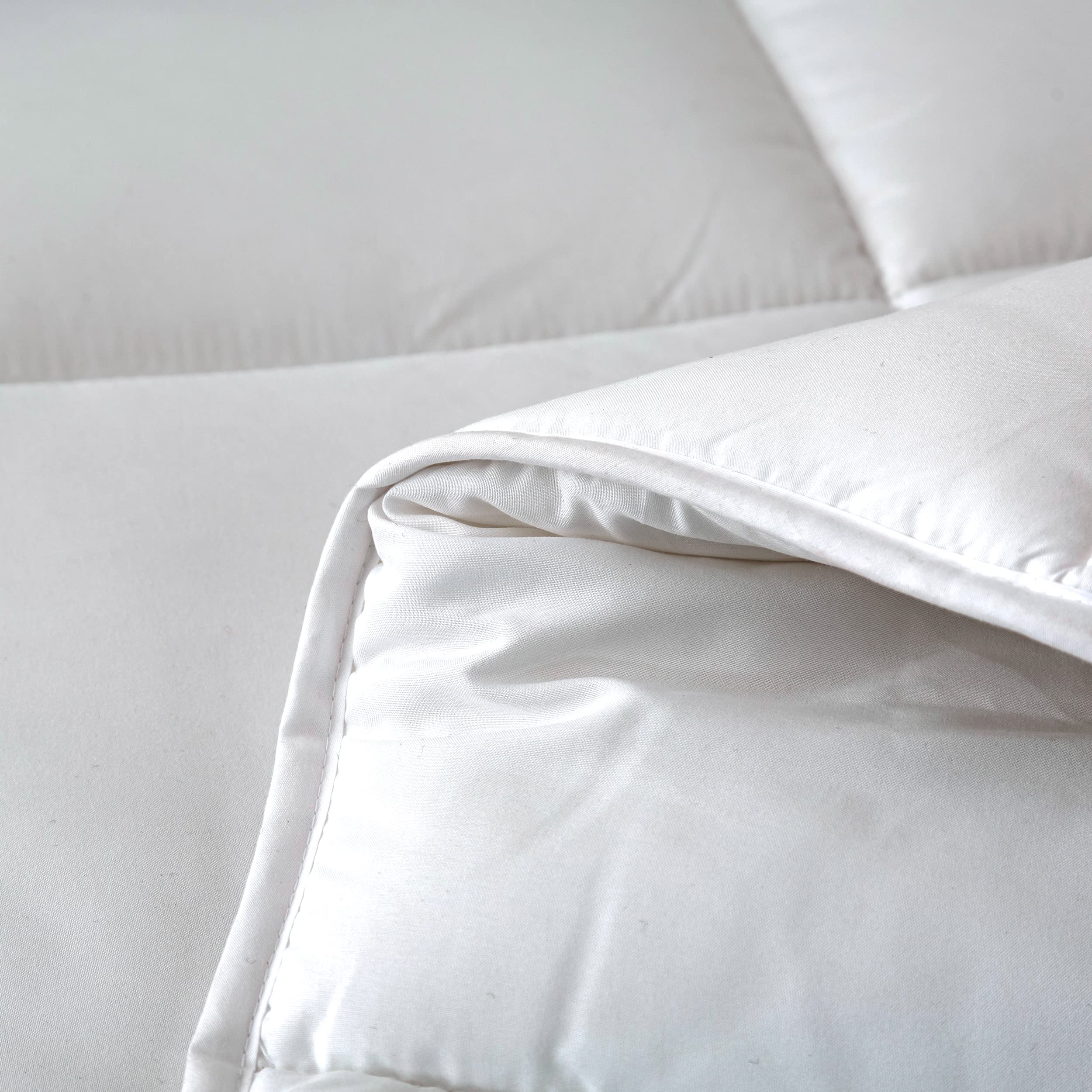 Dorrin Nessin comforter styled on a bedroom to show all-season comfort and aesthetic