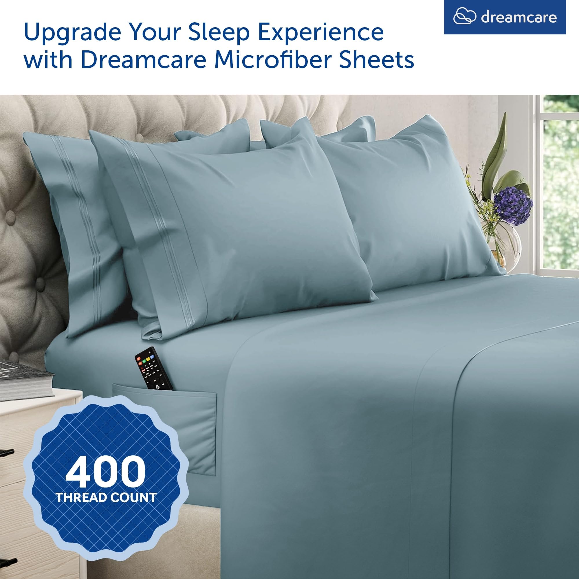DREAMCARE fitted sheet close-up showing extra-deep pocket and secure fit benefit