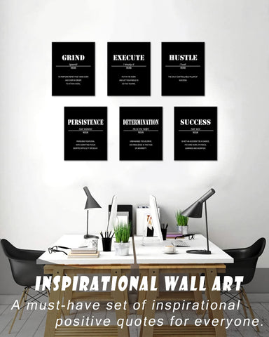 Drsoum desk display with prints by laptop offering focused workspace motivation