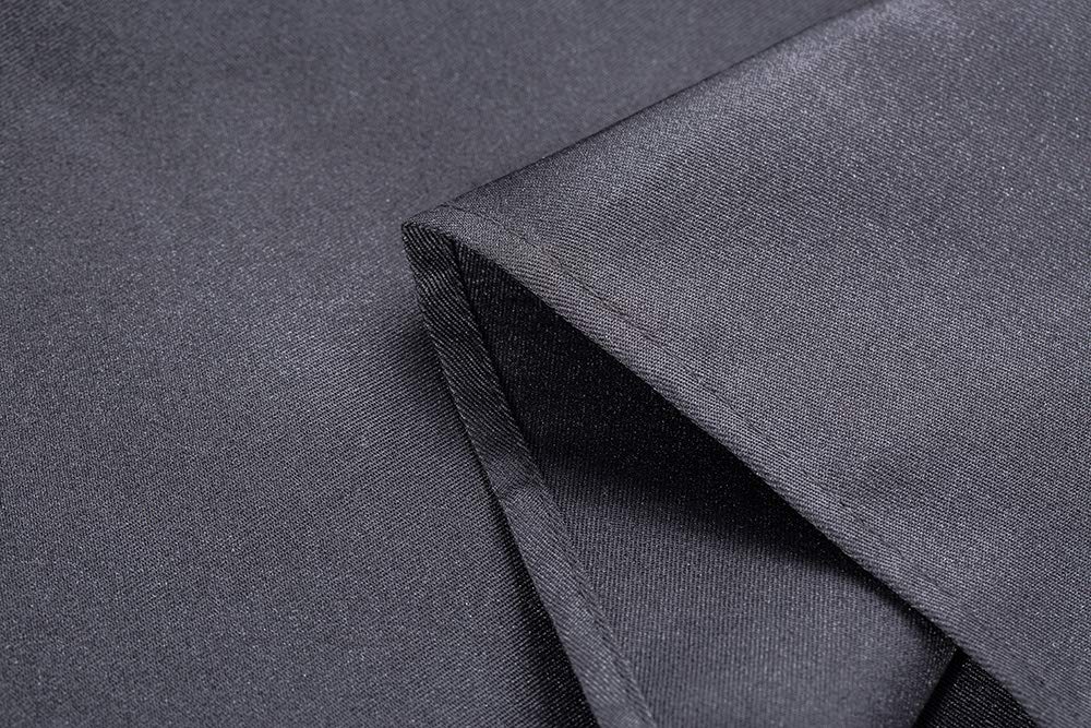 DUSKCOVE tie and label close-up showing reinforced stitching and adjustable ties