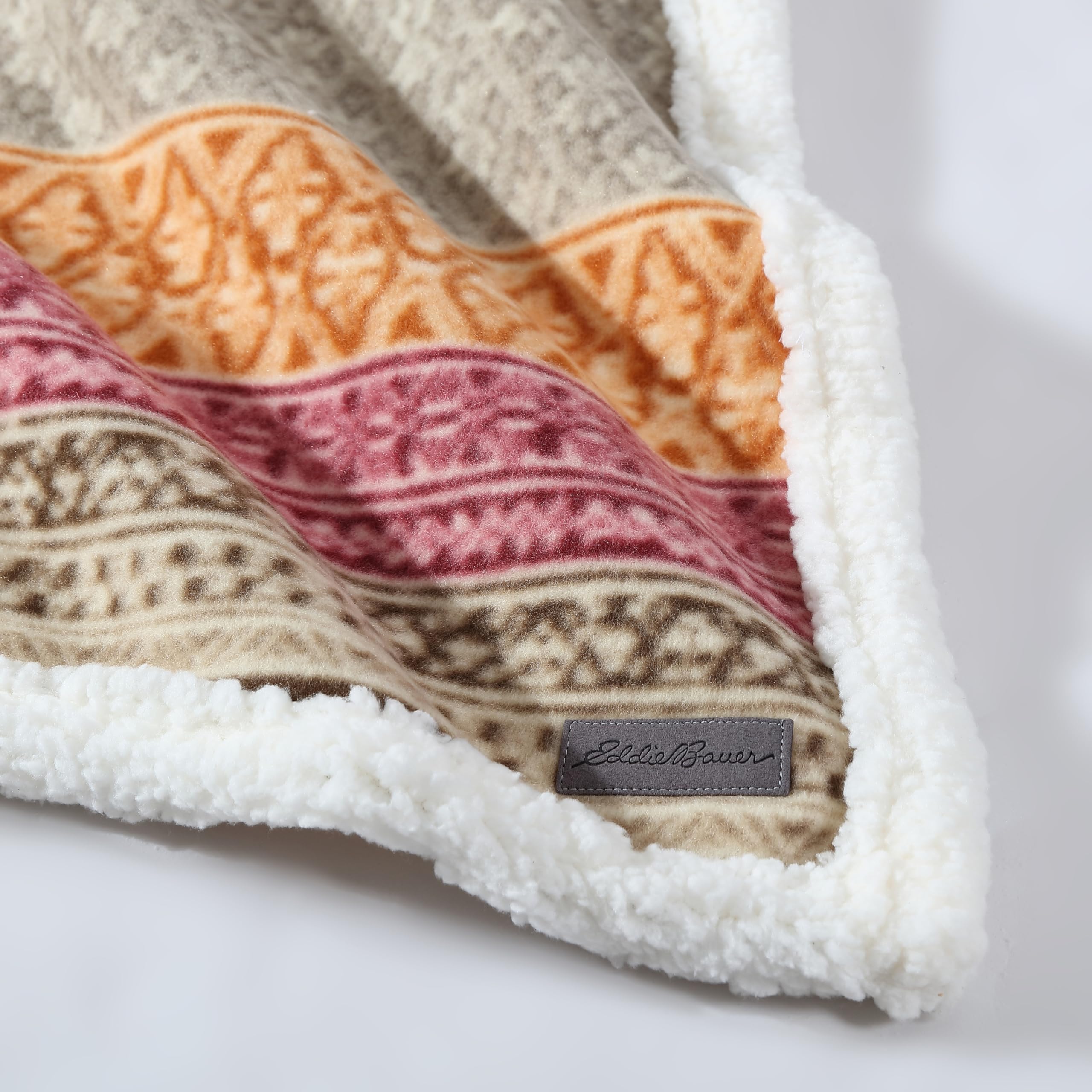 Eddie Bauer folded blanket next to book showing generous 50x70 size