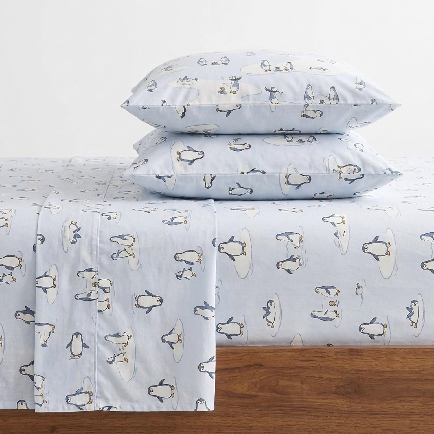 Eddie Bauer front view of Skating Penguin flannel sheet set showing coordinated design and cozy benefit